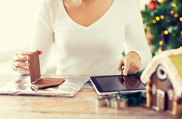 Image showing close up of woman making gingerbread houses