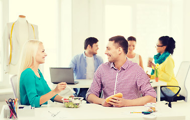 Image showing smiling fashion designers having lunch at office