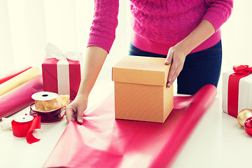 Image showing close up of woman decorating christmas presents