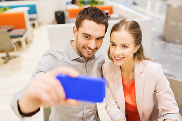 Image showing happy couple taking selfie with smartphone in cafe