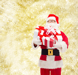 Image showing man in costume of santa claus with gift boxes