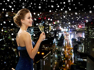 Image showing smiling woman holding glass of sparkling wine