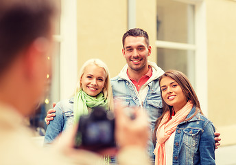 Image showing group of smiling friends taking photo outdoors