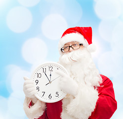 Image showing man in costume of santa claus with clock