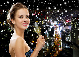 Image showing smiling woman holding glass of sparkling wine