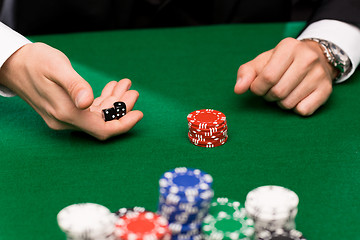 Image showing poker player with dice and chips at casino