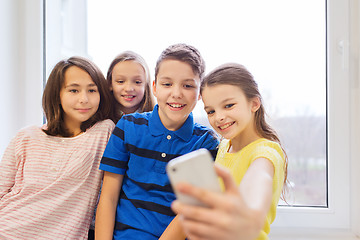 Image showing group of school kids taking selfie with smartphone