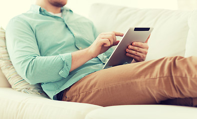 Image showing close up of man with tablet pc computer at home