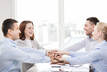 Image showing business team celebrating victory in office