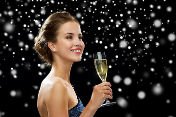 Image showing smiling woman holding glass of sparkling wine