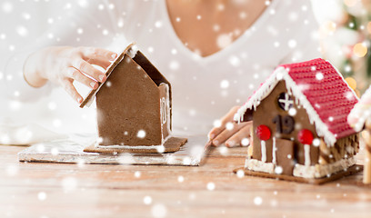 Image showing close up of woman making gingerbread houses