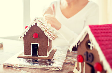 Image showing close up of woman making gingerbread houses