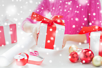 Image showing close up of woman decorating christmas presents