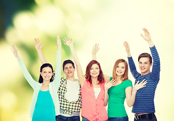 Image showing group of smiling students waving hands