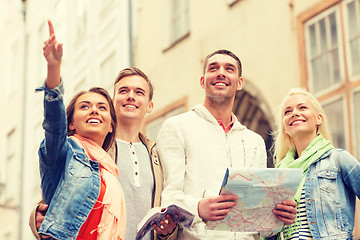 Image showing group of smiling friends with city guide and map