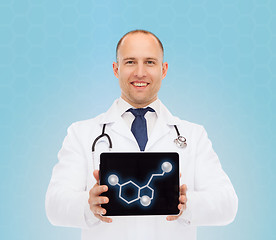 Image showing smiling male doctor showing tablet pc screen