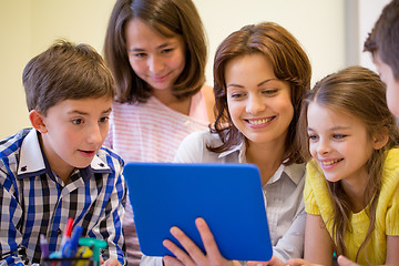 Image showing group of kids with teacher and tablet pc at school