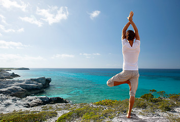 Image showing young man making yoga exercises outdoors