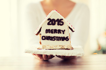 Image showing close up of woman showing gingerbread house