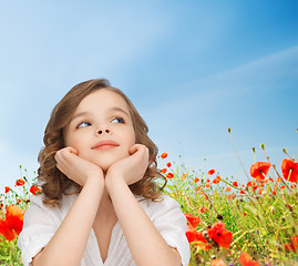 Image showing beautiful girl sitting at table and looking up