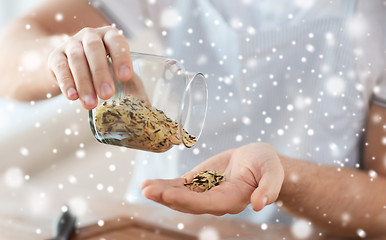 Image showing man emptying jar with white and wild black rice