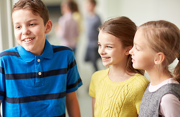 Image showing group of smiling school kids talking in corridor