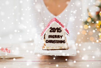 Image showing close up of woman showing gingerbread house