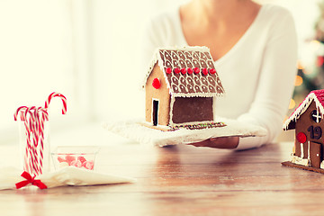 Image showing close up of woman showing gingerbread house