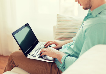 Image showing close up of man working with laptop at home