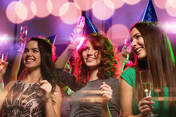 Image showing smiling friends with glasses of champagne in club