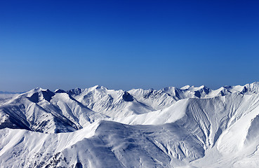 Image showing Winter snowy mountains with avalanche slope at evening