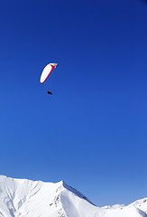 Image showing Paraglider in snowy mountains at nice sun day