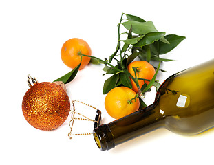 Image showing Empty bottle of wine, muselet, mandarins and Christmas decoratio