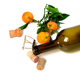 Image showing Empty bottle of wine, corks, muselet and mandarins