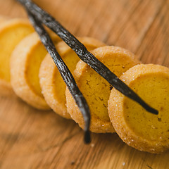 Image showing Fresh baked shortbread cookies with  with vanilla sticks on a wood