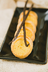 Image showing Fresh baked shortbread cookies with  with vanilla sticks on a wood