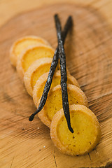 Image showing Fresh baked shortbread cookies with  with vanilla sticks on a wood