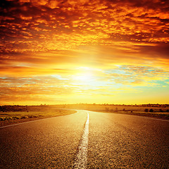 Image showing good red sunset and asphalt road to horizon