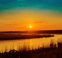 Image showing orange sunset over river