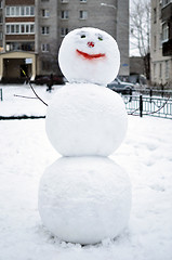 Image showing Snowman in the yard of the house.