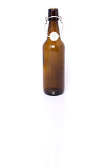 Image showing Old brown bottle of beer isolated on white.