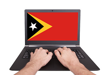 Image showing Hands working on laptop, East Timor