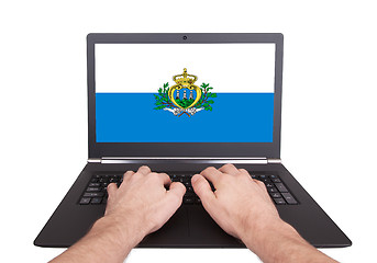 Image showing Hands working on laptop, San Marino