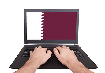 Image showing Hands working on laptop, Qatar