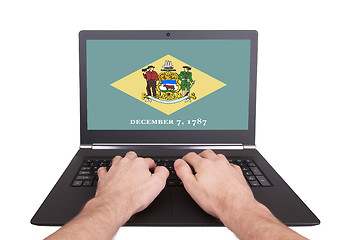 Image showing Hands working on laptop, Delaware