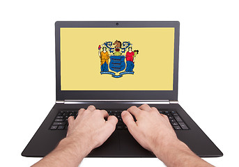 Image showing Hands working on laptop, New Jersey