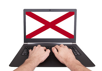 Image showing Hands working on laptop, Alabama