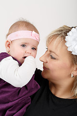 Image showing Loving mother embracing her baby girl