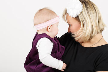 Image showing Loving mother embracing her baby girl