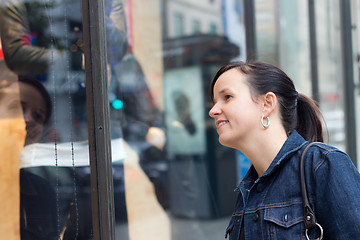 Image showing Woman looking for a deal while window shopping